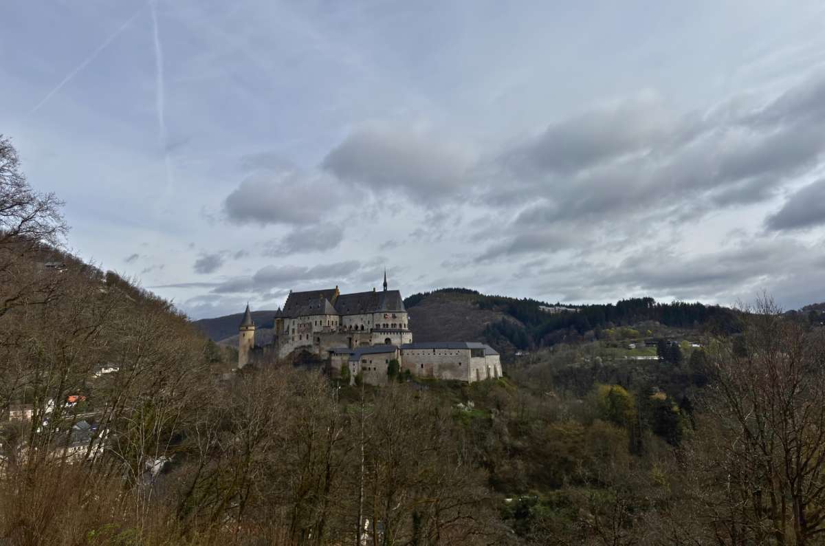 Vianden Castle on its forested ridge across the valley, Vianden, Luxembourg, photo by Next Level of Travel