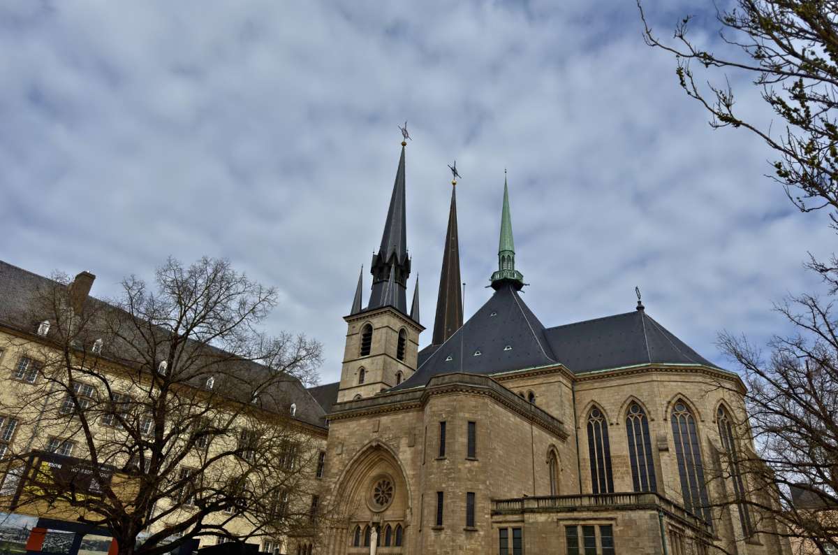 a photo of the spires of Notre-Dame Cathedral under heavy clouds, Luxembourg City, photo by Next Level of Travel