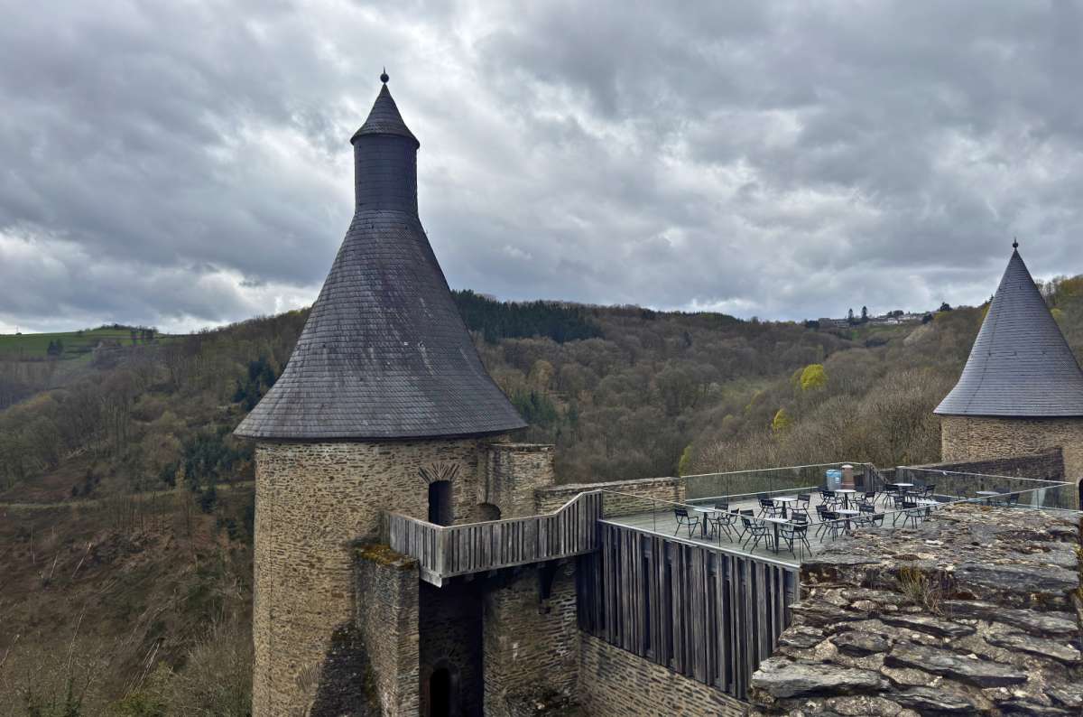 a photo of the towers and ramparts of Bourscheid Castle under a dramatic sky, Bourscheid, photo by Next Level of Travel