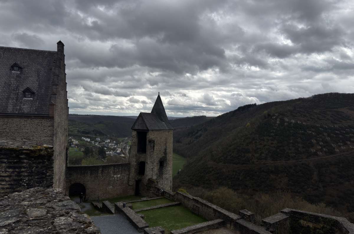 a photo of a pointed-roof turret of Bourscheid Castle with the valley behind, Bourscheid, Luxembourg, photo by Next Level of Travel