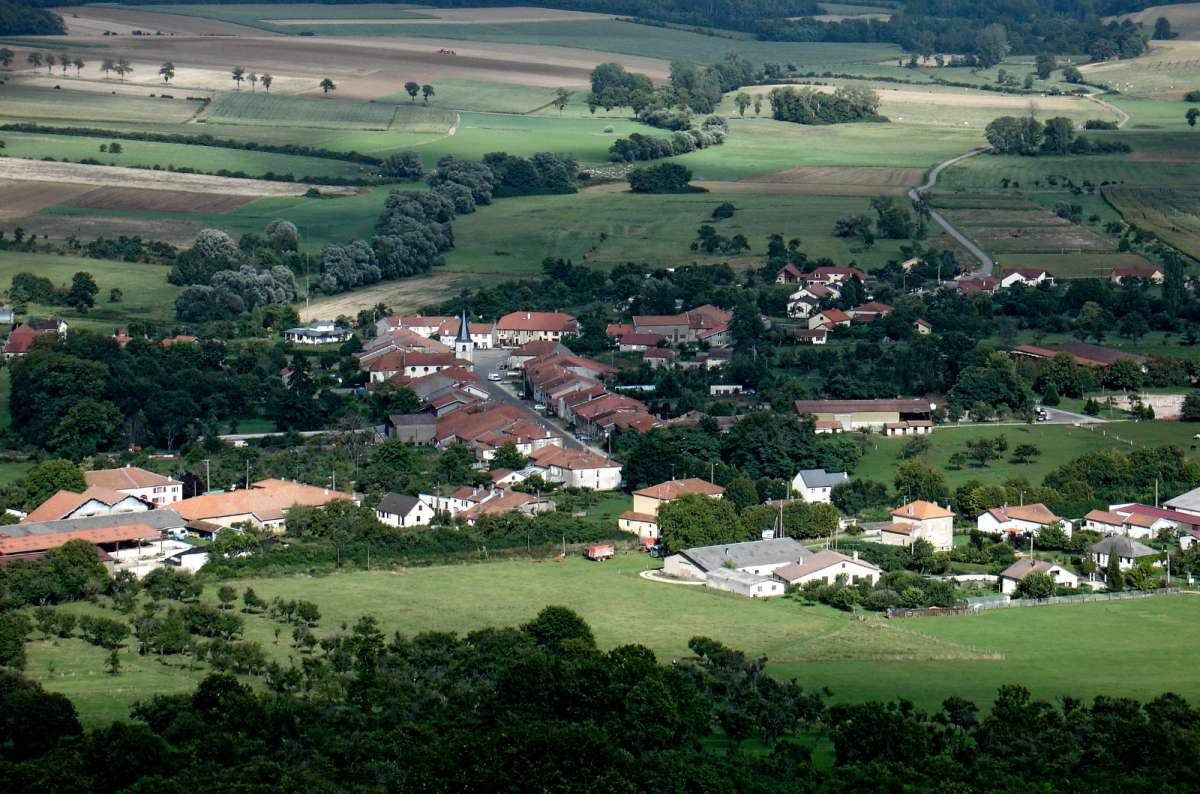a photo of a village spread across open farmland and rolling fields, Belgian Ardennes near Bastogne