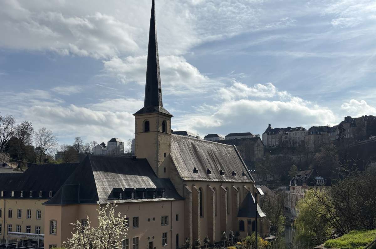 a photo of Neimënster Abbey and the Grund quarter beside the Alzette river below the cliffs, Luxembourg City, Luxembourg, photo by Next Level of Travel 