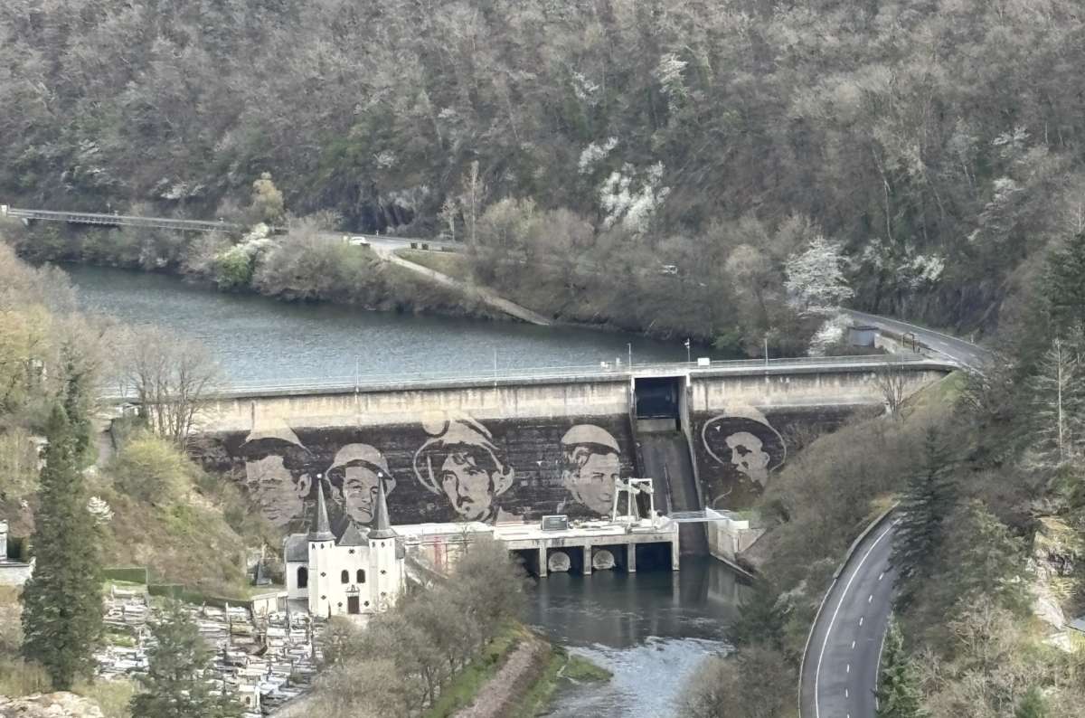 a photo of the Esch-sur-Sûre dam and the village rooftops on the Sûre river, Esch-sur-Sûre, Luxembourg, photo by Next Level of Travel 