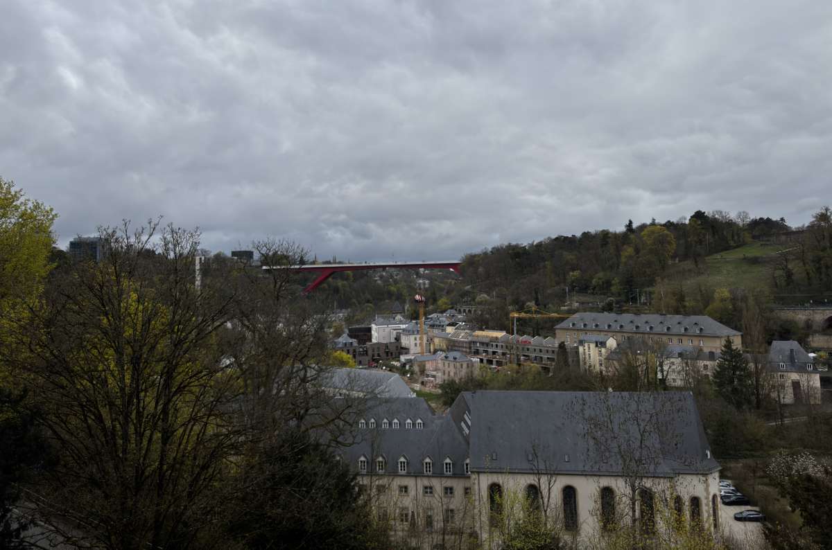 a photo of the Grund and Neimënster Abbey below the cliffs on a moody day, Luxembourg City, Luxembourg, photo by Next Level of Travel
