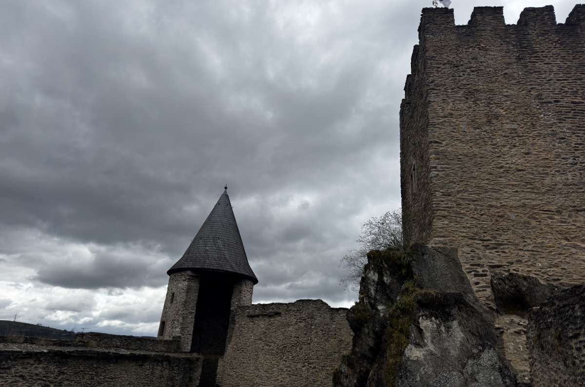 a photo of the ruined walls and towers of Bourscheid Castle above the Sûre valley, Bourscheid, Luxembourg, photo by Next Level of Travel 