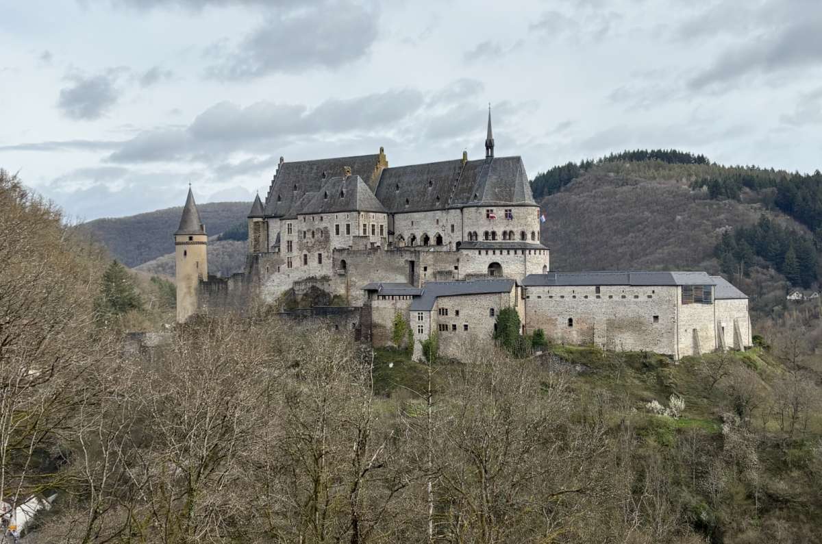 a photo of Vianden Castle high on the rock seen from across the valley, Vianden, Luxembourg, photo by Next Level of Travel