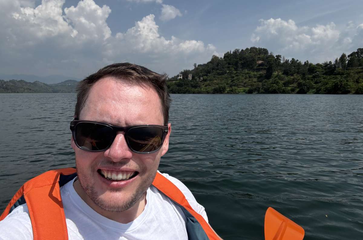 a photo of a small wooden fishing boat on the still surface of Lake Kivu, Lake Kivu, Rwanda, photo by Next Level of Travel