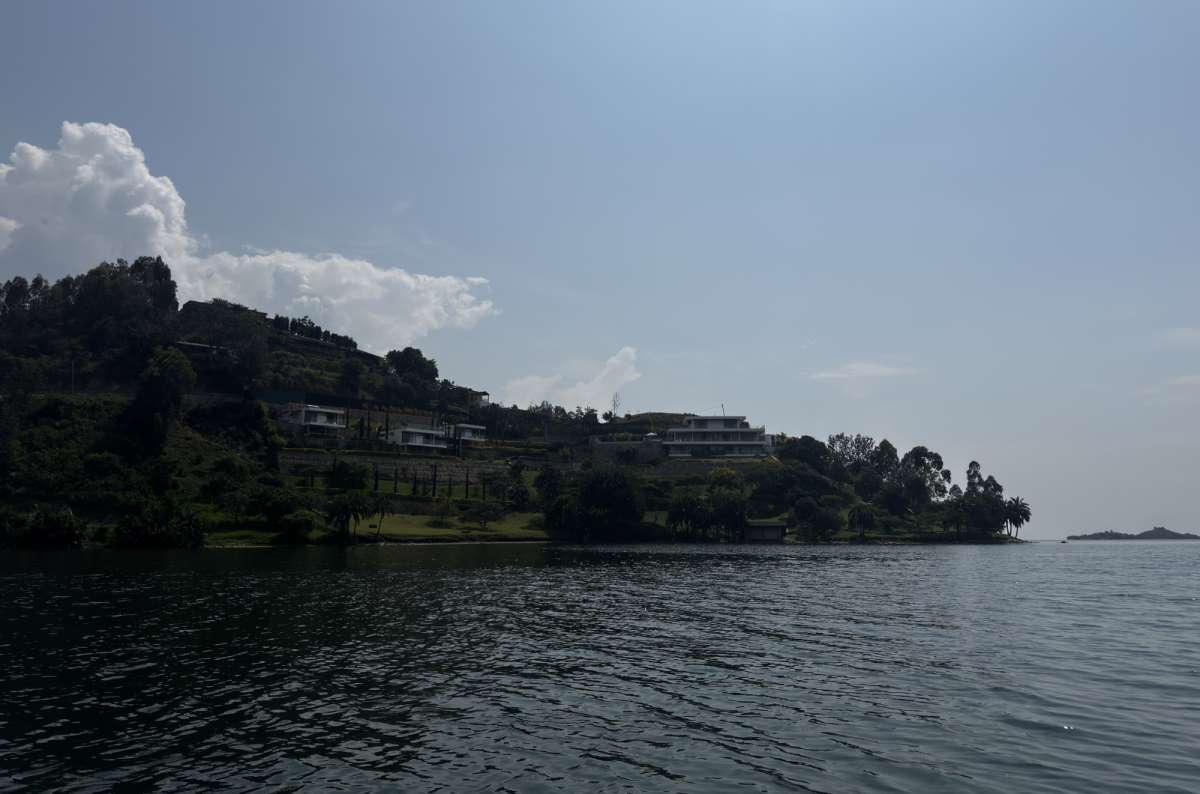 a photo of Lake Kivu dotted with green islands and framed by palm trees, Lake Kivu, Rwanda, photo by Next Level of Travel