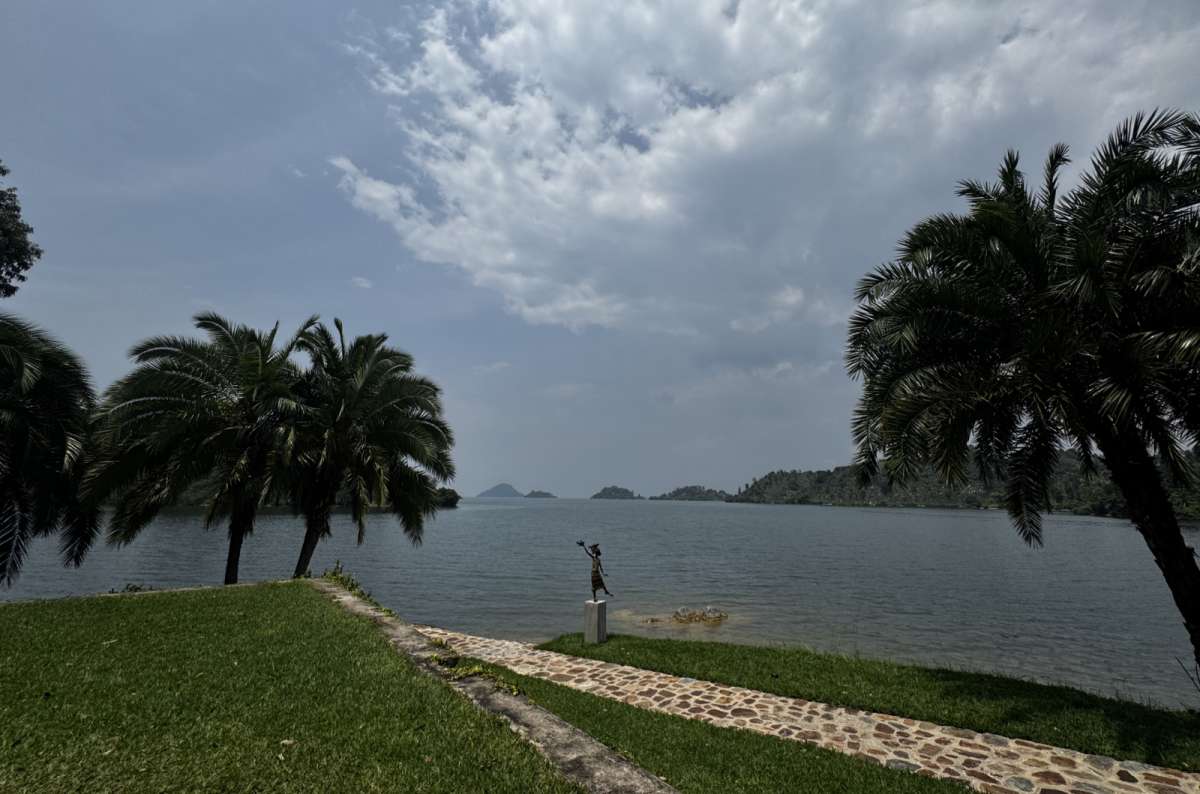 a photo of the calm, island-dotted water of Lake Kivu seen from the shore, Lake Kivu, Rwanda, photo by Next Level of Travel 