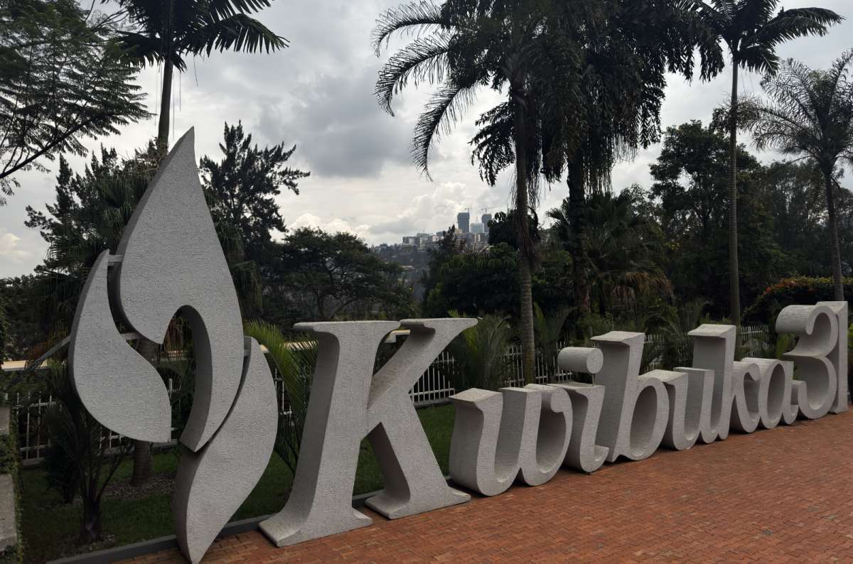 a photo of the Kwibuka commemoration flame sign framed by palms at the Kigali Genocide Memorial, Kigali, Rwanda, photo by Next Level of Travel