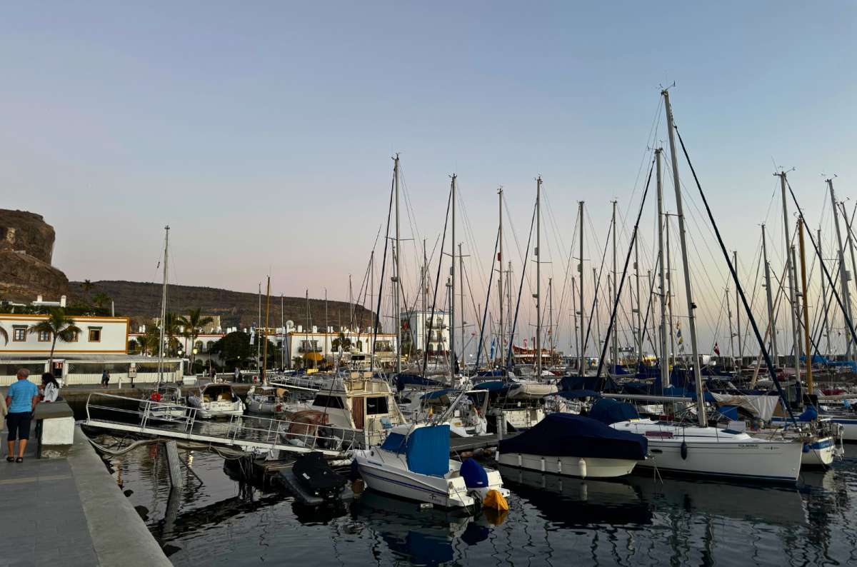 a photo of sailboats and yachts docked in the Puerto de Mogán marina at dusk, Gran Canaria, photo by Next Level of Travel