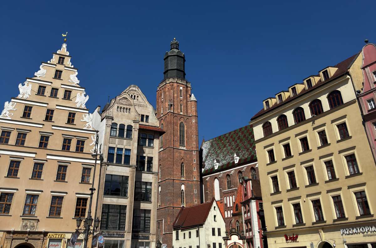 a photo of the main square in Wroclaw with St. Elizabeth Church and tower in the center of the shot, Poland, photo by Next Level of Travel
