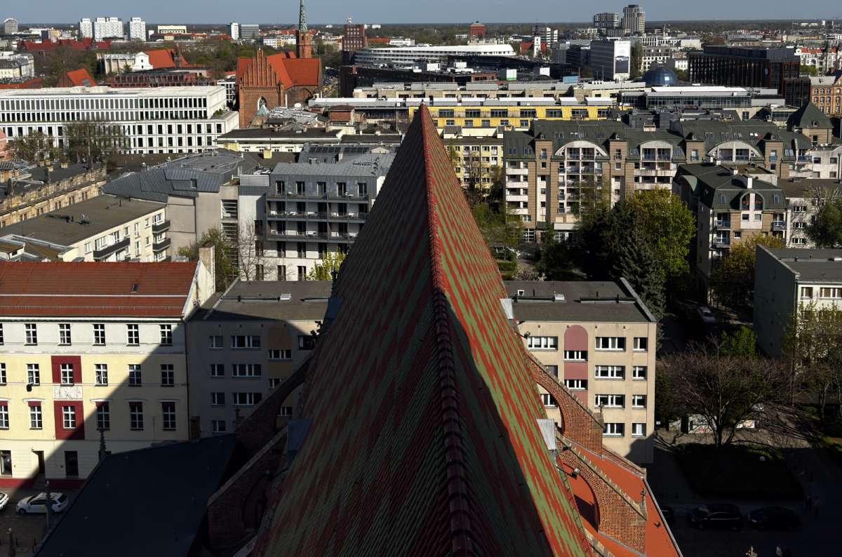 a photo of the Witches’ Bridge from close-up, showing its decorative colors and the historical center of Wroclaw below, Poladnd, photo by Next Level of Travel
