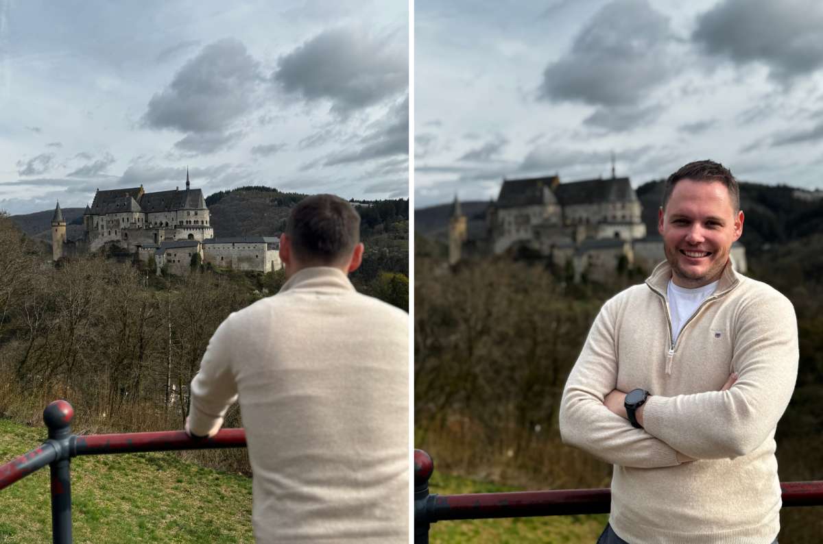 photo of a tourist looking out at Vianden Castle and posing with the castle behind him, Luxembourg, photo by Next Level of Travel