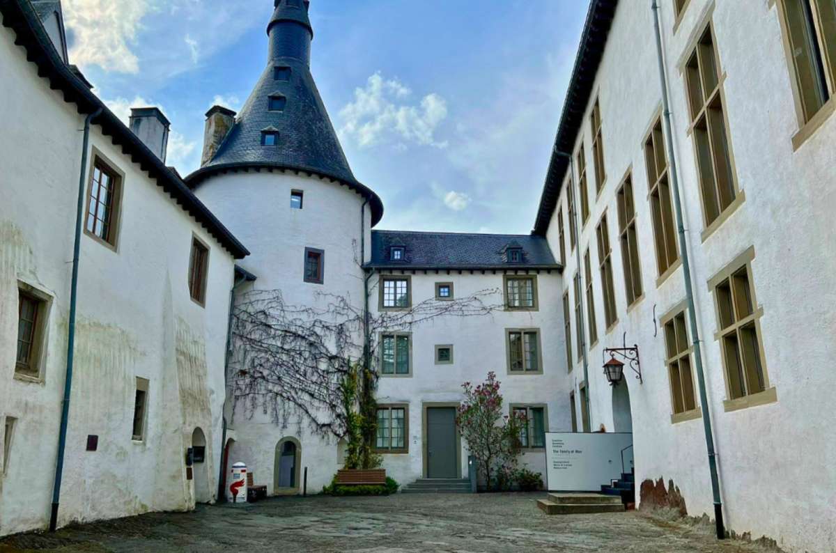 photo of courtyard and round tower of Clervaux Castle, Luxembourg