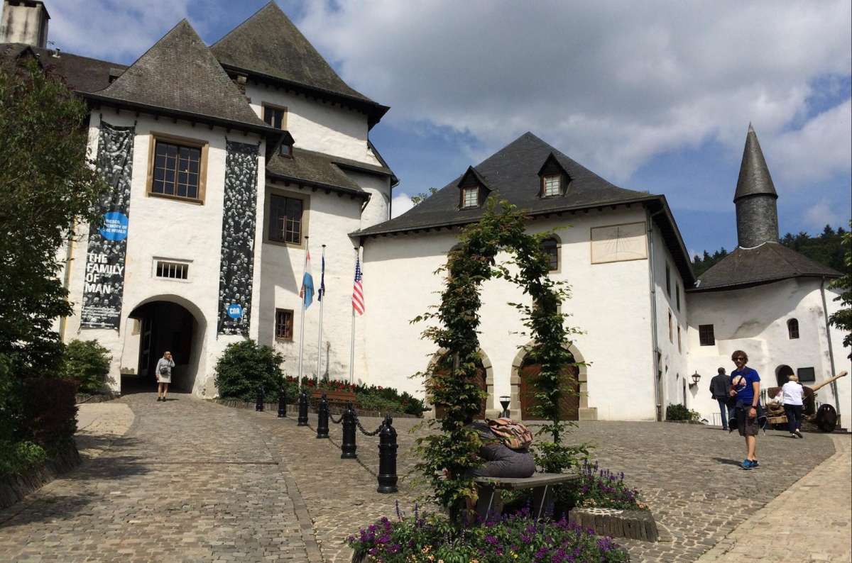a photo showing the courtyard of Clervaux Castle and 