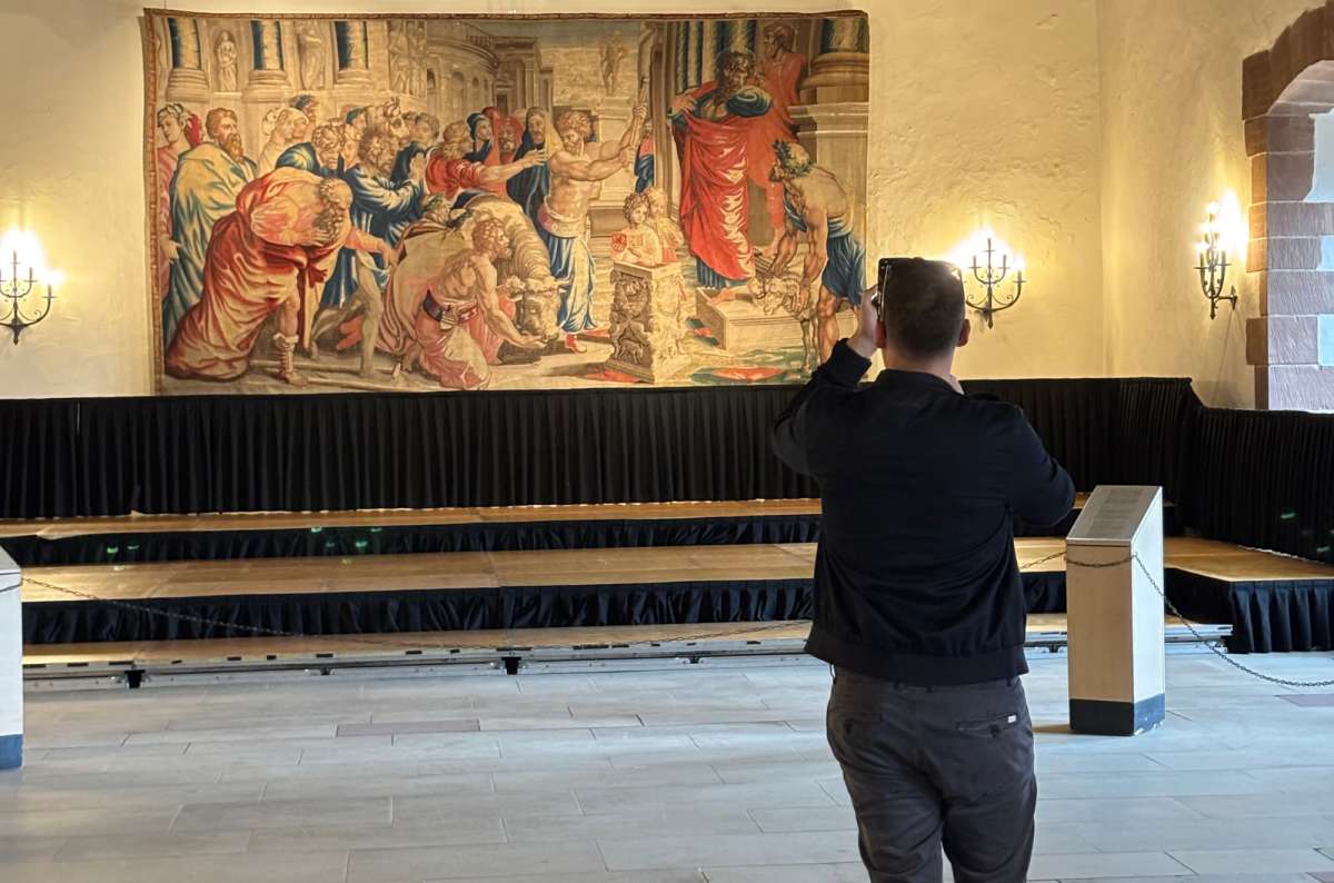 a tourist standing in the Knight’s Hall of the Vianden Castle, Luxembourg, a photo by Next Level of Travel