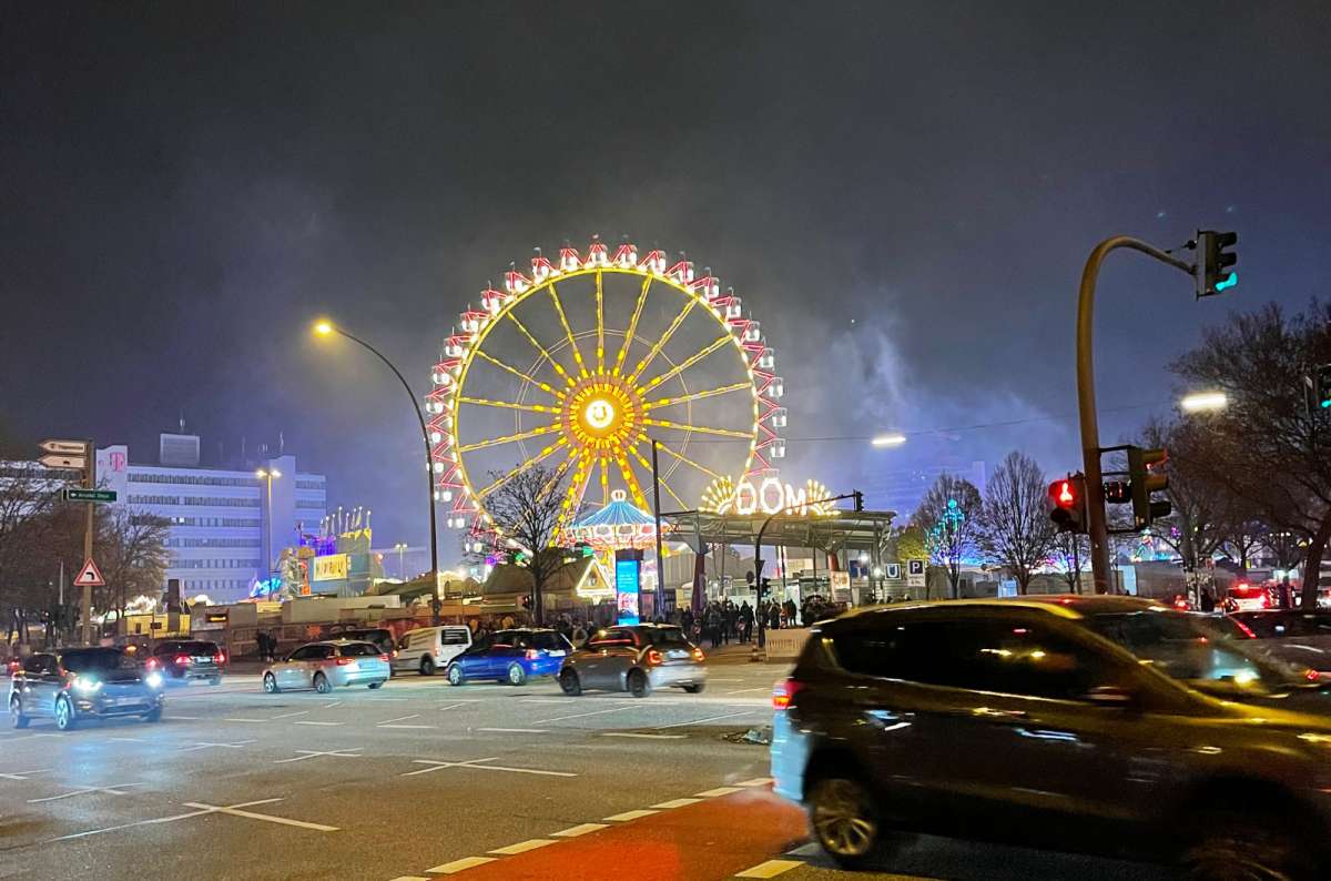 a photo of the ferris wheel at the Hamburger DOM lit up at night, Hamburg, Germany, photo by Next Level of Travel