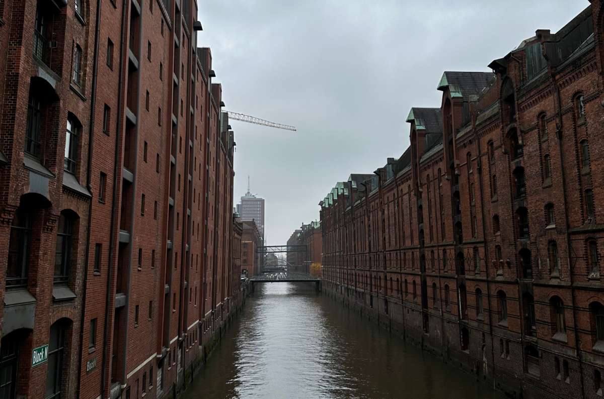 a photo of the HafenCity canal surrounded by brick buildings, Germany, photo by Next Level of Travel