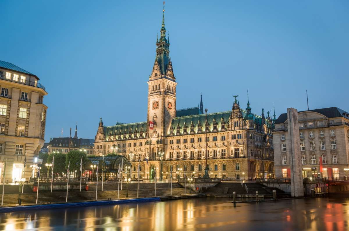 a photo of the Hamburg Rathaus exterior and the surrounding square, showing its decorative clock tower, Germany