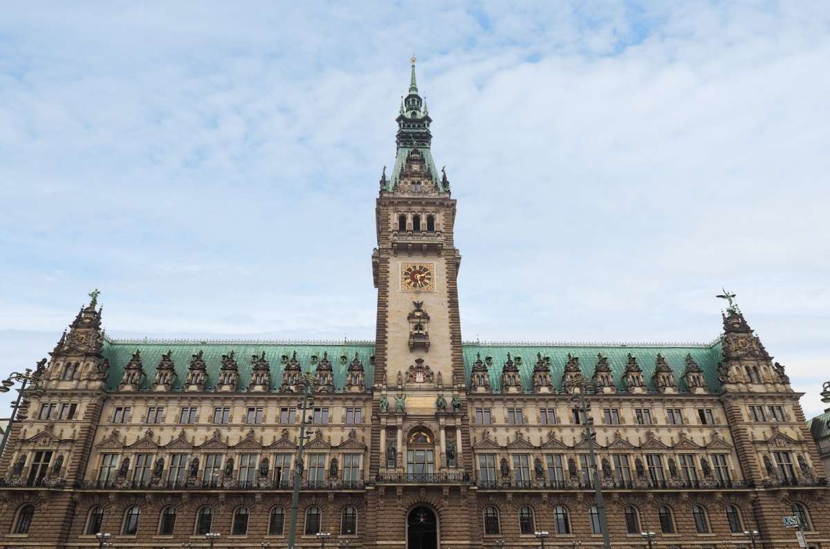 a photo of the Hamburg Rathaus exterior, showing its decorative clock tower, Germany