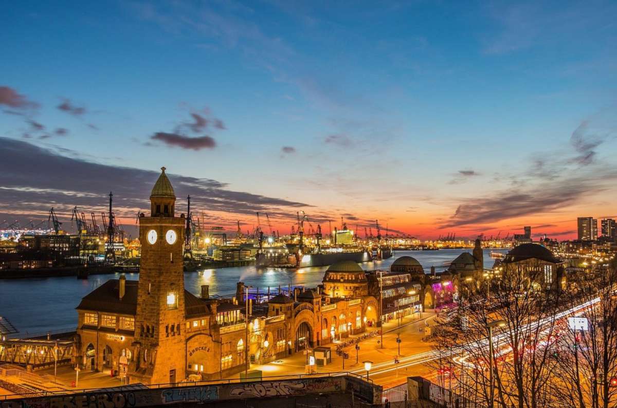 a phtoto from one of the Landungsbrücken in Hamburg, showing the decorative buildings and the Elbe river in the background, Germany