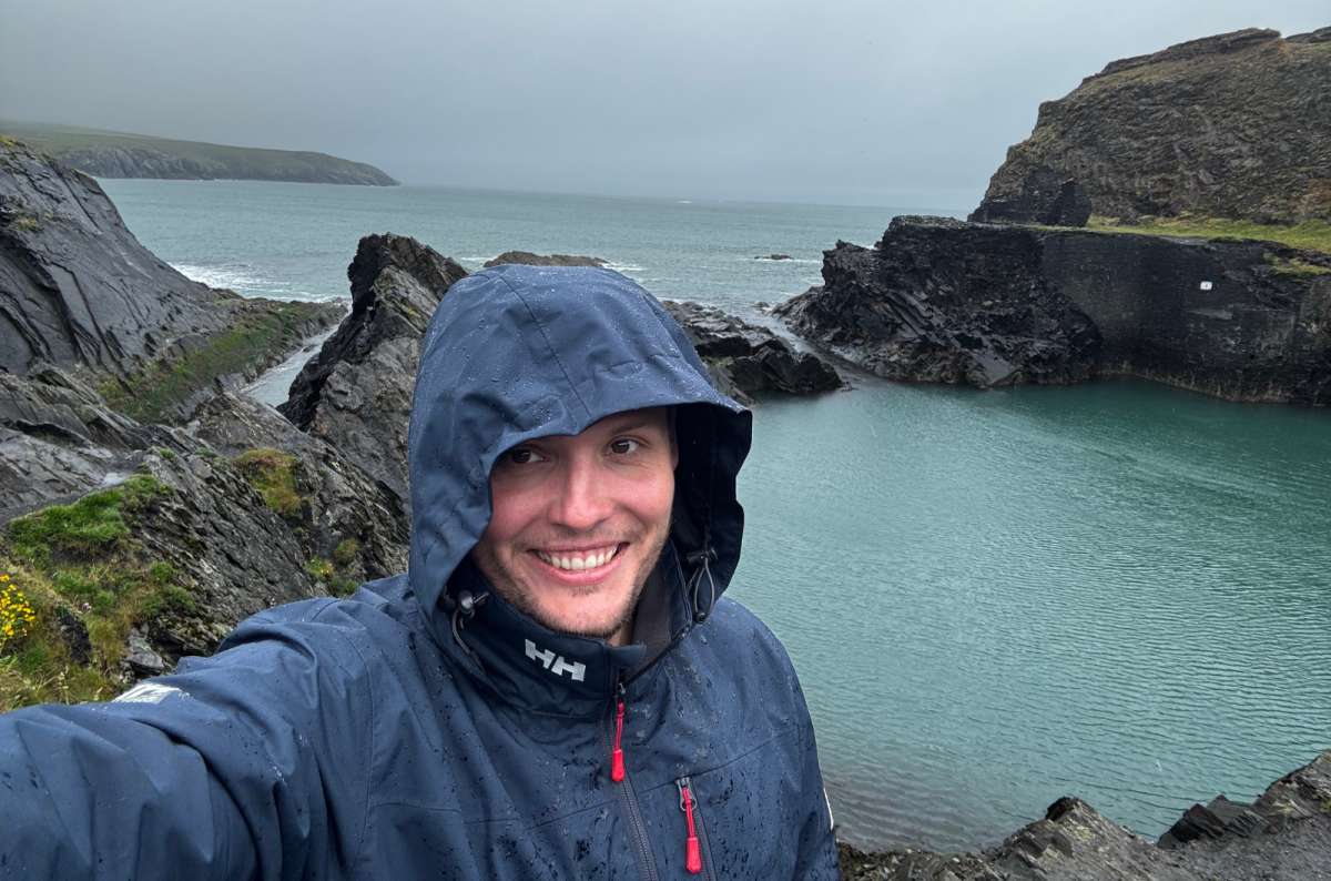 photo of a tourist in a rain jacket at the Blue Lagoon, Abereiddy, Pembrokeshire, photo by Next Level of Travel