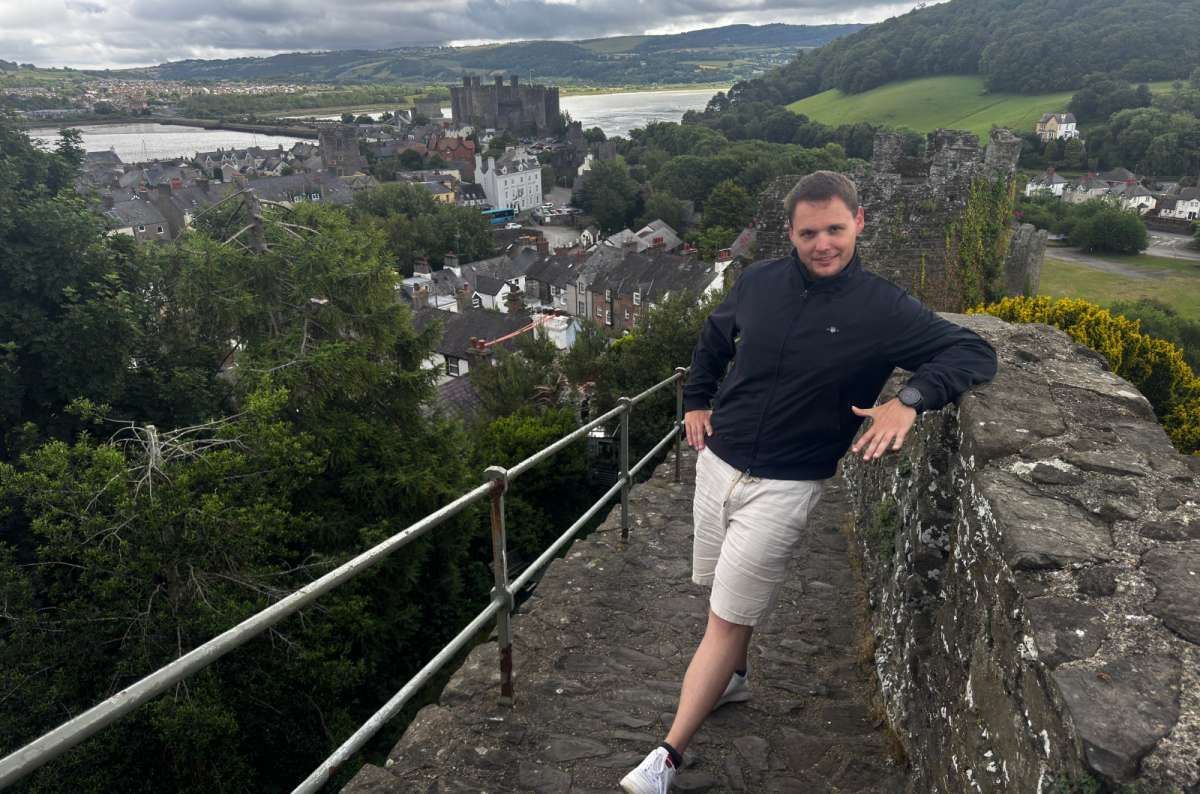 photo of a tourist on the town walls overlooking Conwy Castle , North Wales, photo by Next Level of Travel