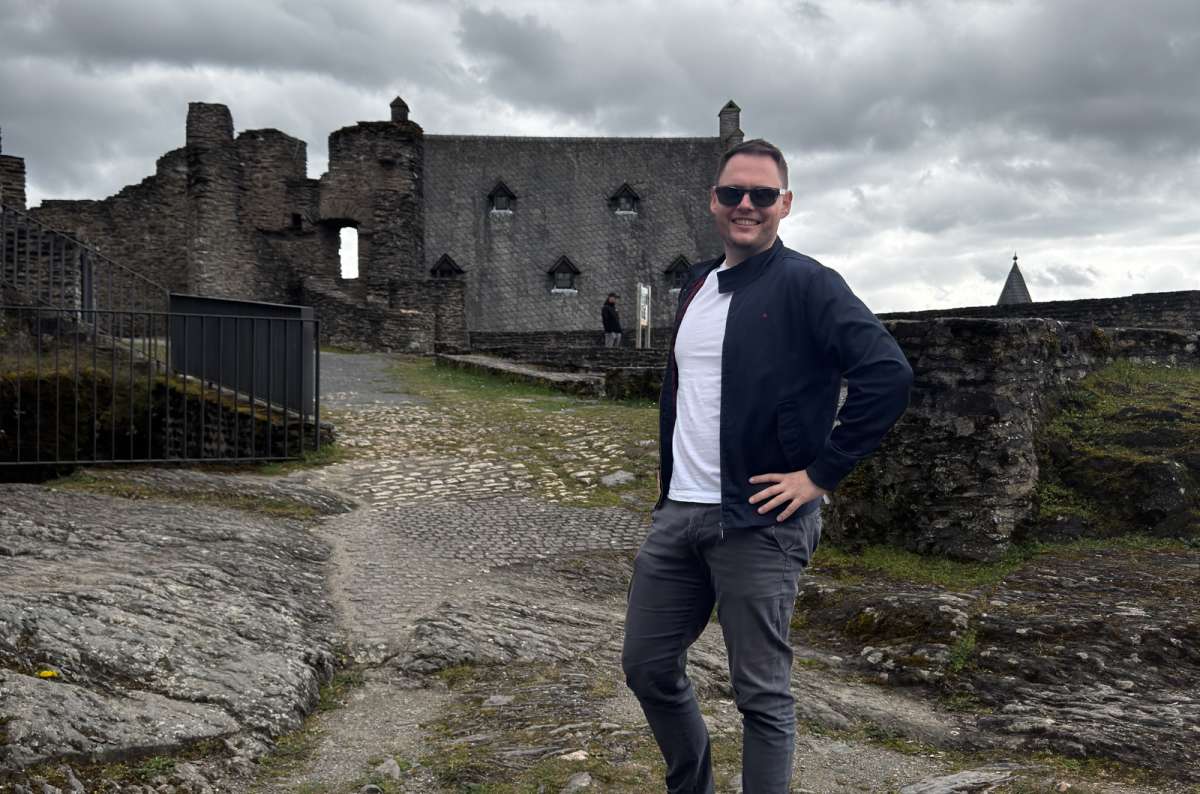 A tourist among the ruined ramparts of Bourscheid Castle above the Sûre valley, Bourscheid, Luxembourg, photo by Next Level of Travel