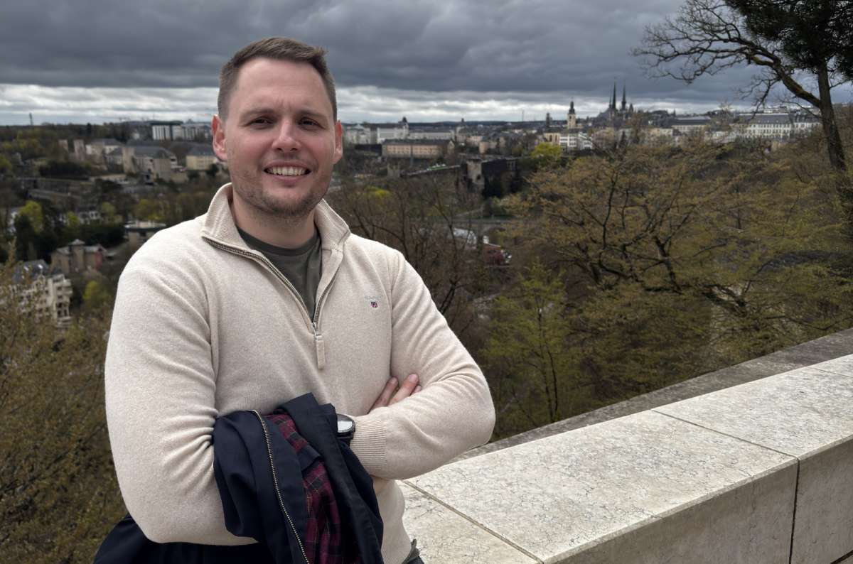 A tourist at a viewpoint over the city under a cloudy sky, Luxembourg City, Luxembourg, photo by Next Level of Travel