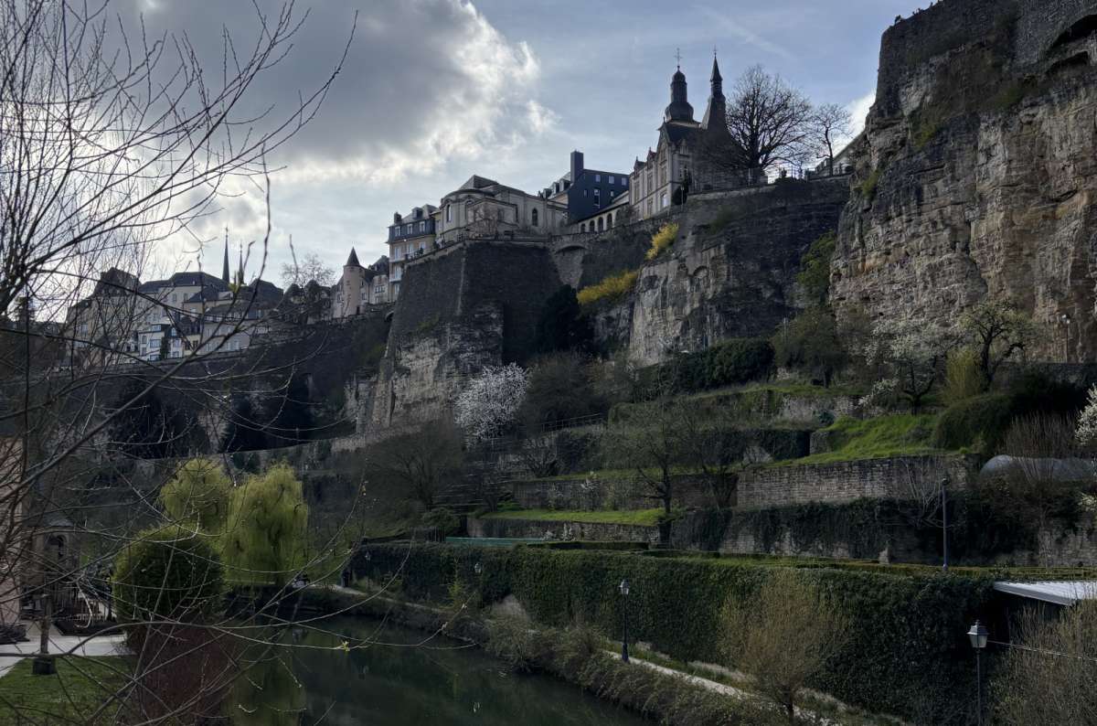 Reflections of cliffs and houses in the calm Alzette river in the Grund, Luxembourg City, Luxembourg, photo by Next Level of Travel