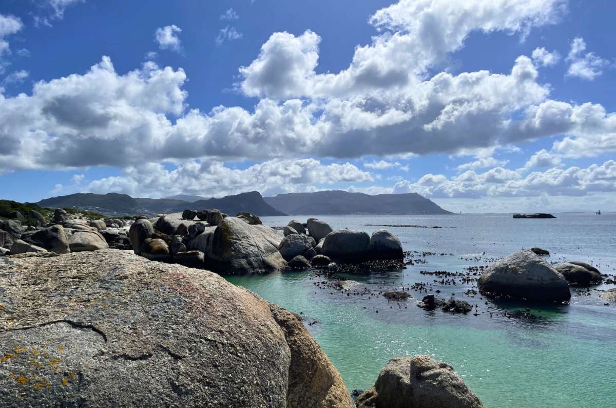 Granite boulders and turquoise water at Boulders Beach in Simon's Town, Cape Peninsula, South Africa, photo by Next Level of Travel