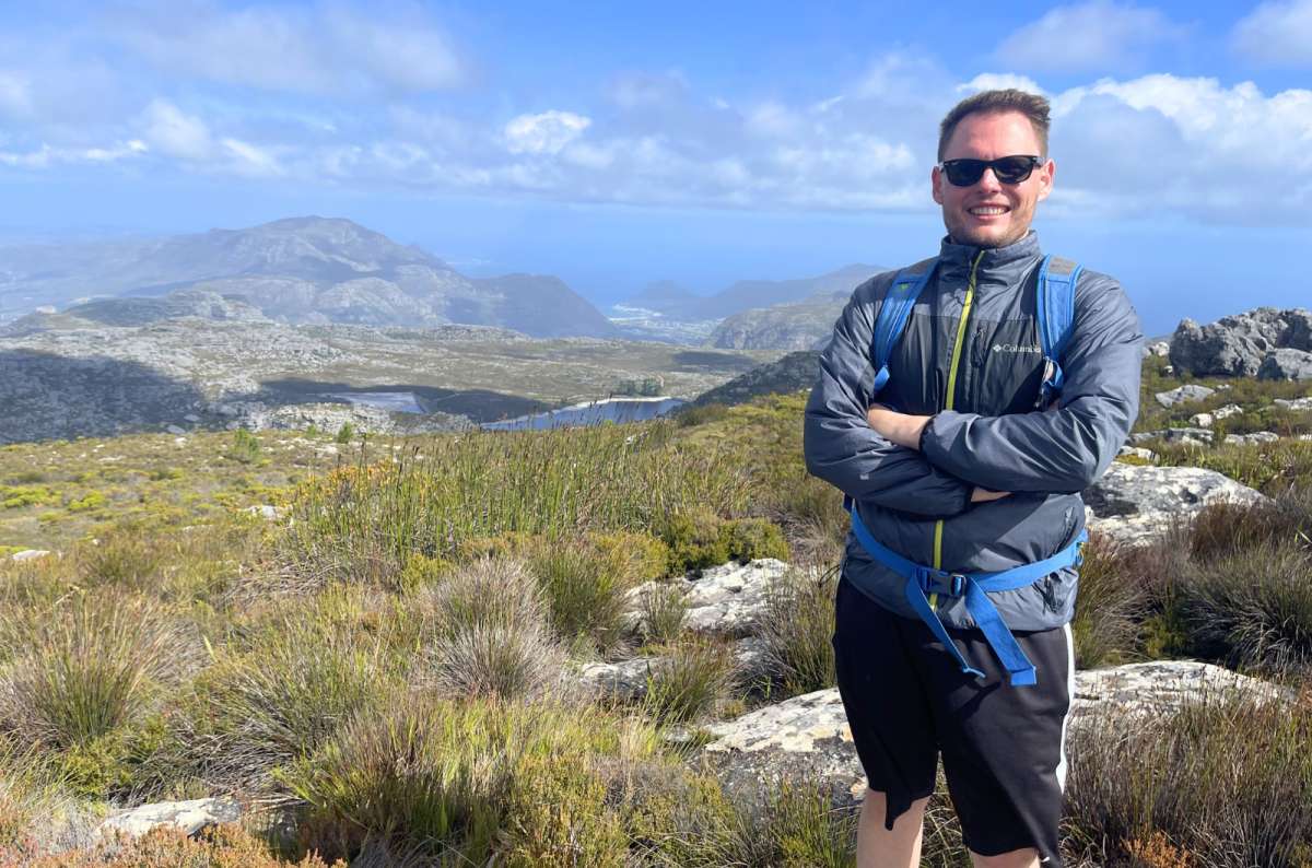 Hiker overlooking the mountains and reservoirs from the Table Mountain Plateau, Table Mountain National Park, Cape Town, South Africa, photo by Next Level of Travel