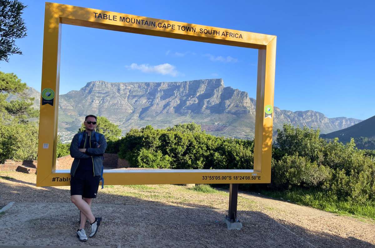 Traveler posing at the Table Mountain viewpoint frame in Cape Town, South Africa, photo by Next Level of Travel