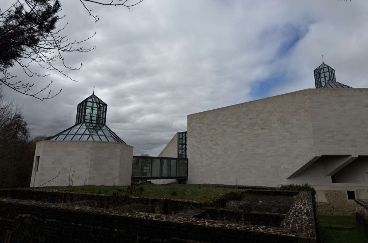 a photo of the MUDAM modern art museum with white limestone walls and geometric glass pyramid skylights, Kirchberg, Luxembourg, photo by Next Level of Travel