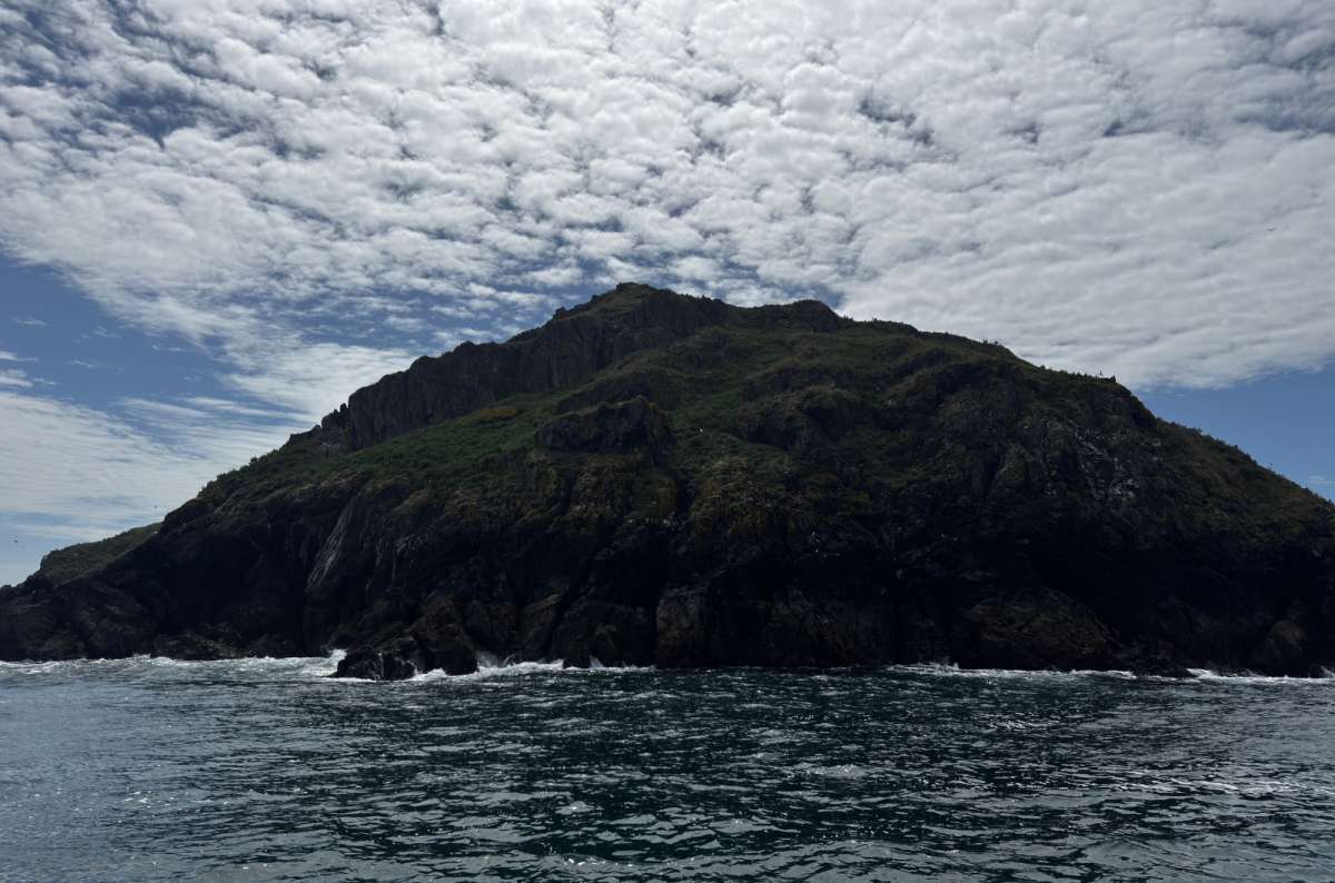 a photo of a mountainous island surrounded by water, Skomer Island, Wales, photo by Next Level of Travel
