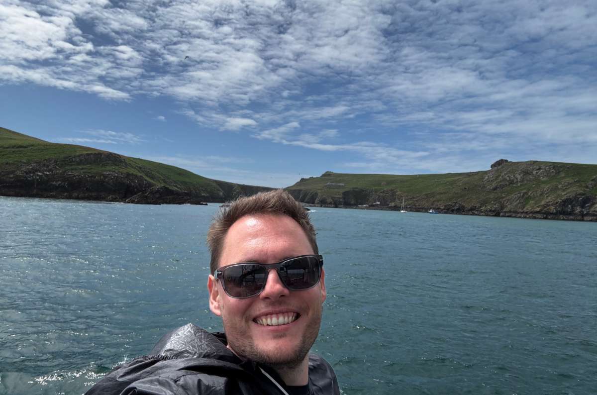 a tourist taking a slefie while on a cruise around Skomer Island, Wales, photo by Next Level of Travel