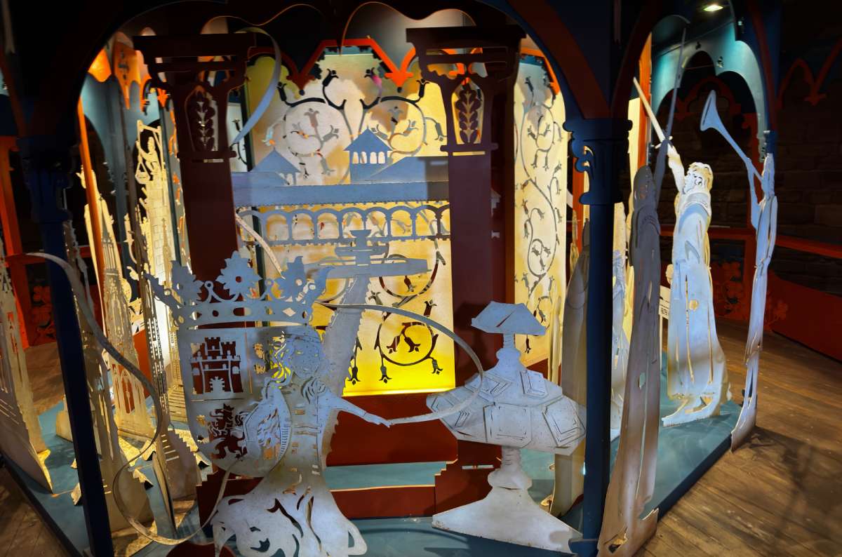 a photo of a paper-cut silhouette exhibit inside a tower at Caernarfon Castle, Caernarfon, Wales, photo by Next Level of Travel