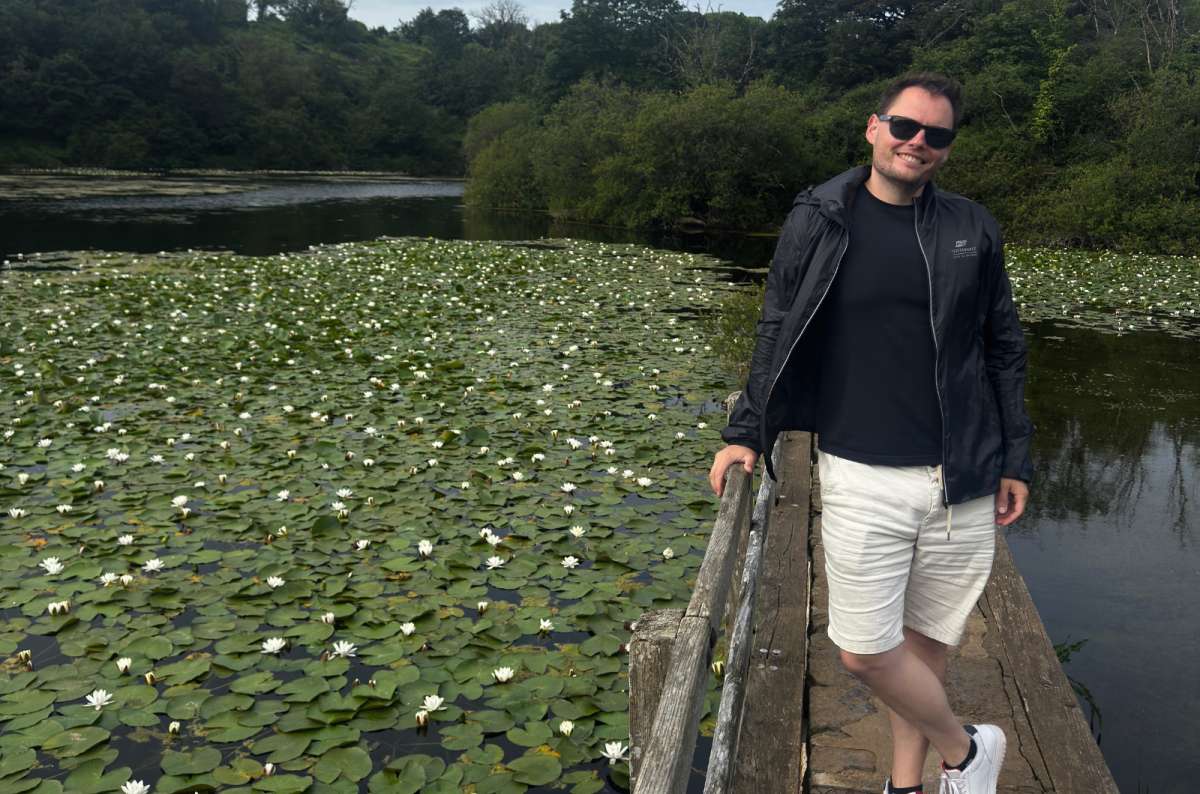 a photo of a tourist on a wooden walkway over the water lilies of Bosherston Lily Ponds, Bosherston, Wales, photo by Next Level of Travel