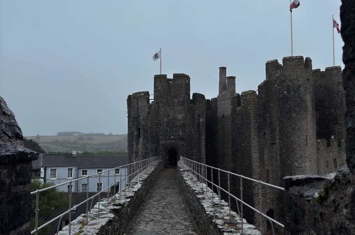 a photo of the wall walkway leading to the towers of Pembroke Castle in the mist, Pembroke, Wales, photo by Next Level of Travel