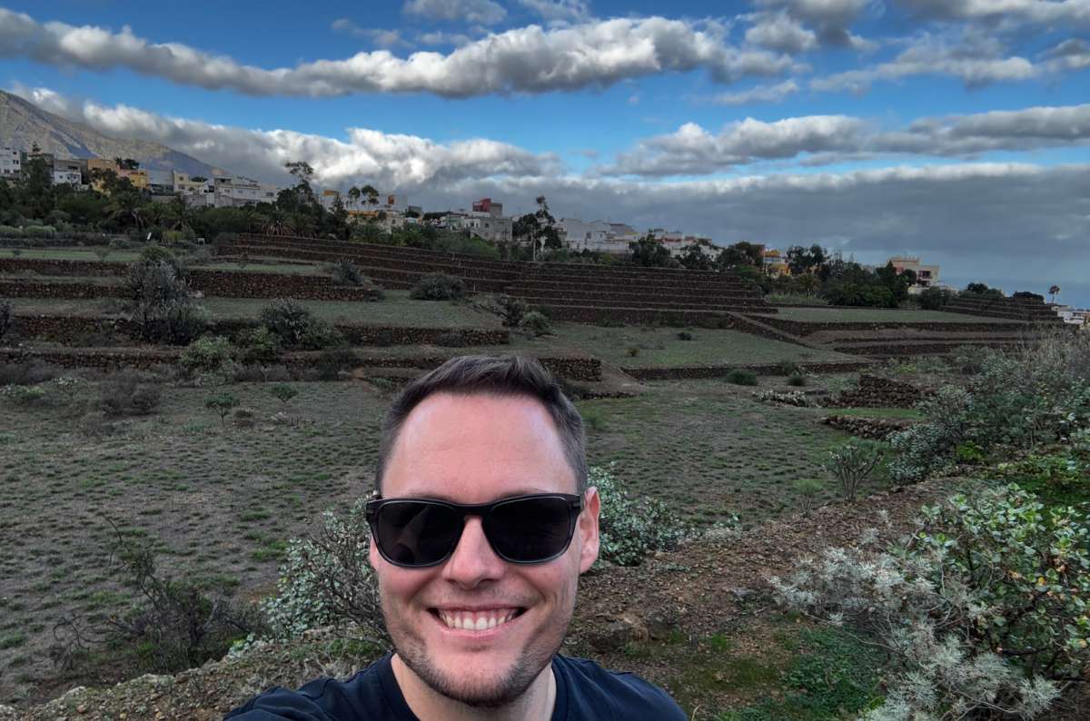 A photo showing a tourist posing in front of the Pyramids of Güímar in Tenerife, a photo by Next Level of Travel