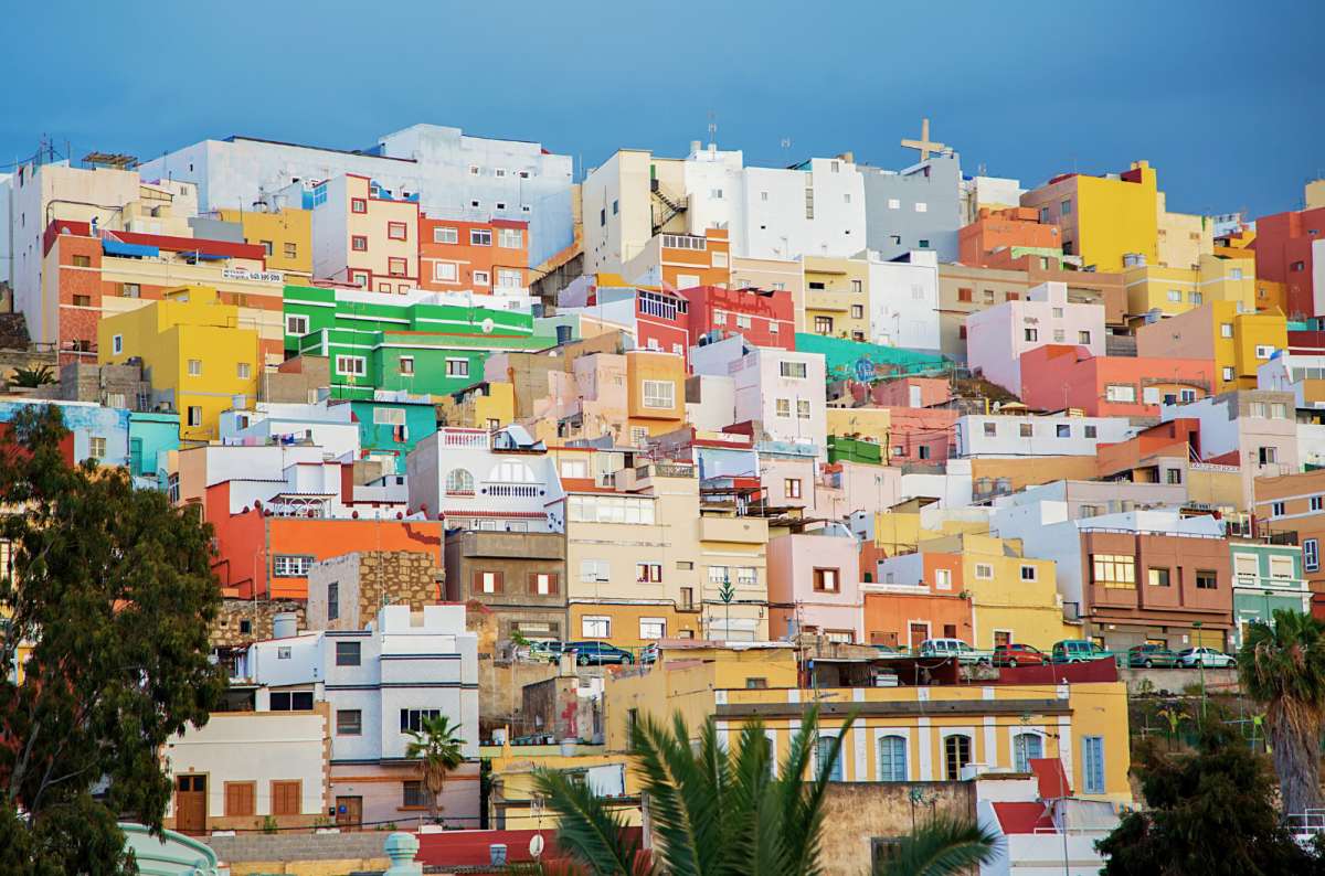 a photo of brightly coloured houses stacked up a hillside in the San Juan neighbourhood, Las Palmas, Canary Islands