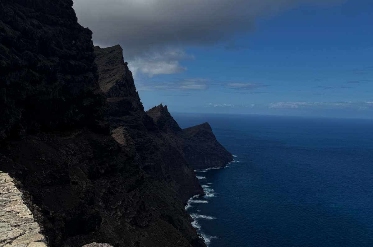 a photo of steep dark cliffs plunging into the deep blue Atlantic seen from the Mirador del Balcón viewpoint, Canary Islands, photo by Next Level of Travel