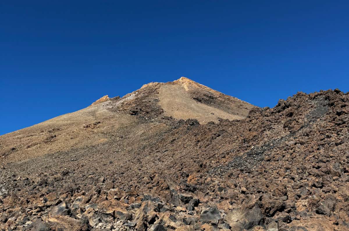 a photo of Mount Teide's barren volcanic peak and lava rock terrain, Teide National Park, Tenerife, photo by Next Level of Travel