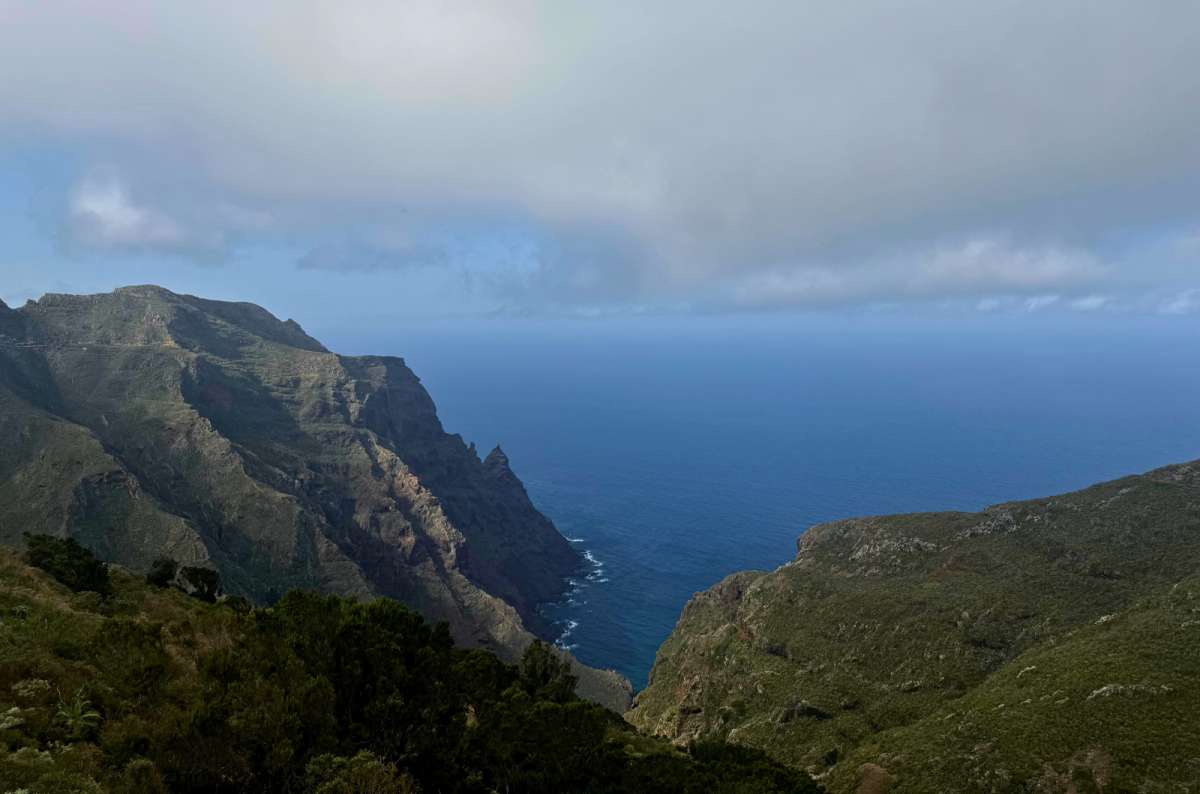 a photo of steep green cliffs dropping into the Atlantic under clouds, Anaga Rural Park, Tenerife, photo by Next Level of Travel