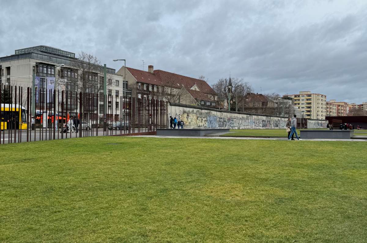 A photo showing the Berlin Wall Memorial and the surrounding grass area, Germany, a photo by Next Level of Travel