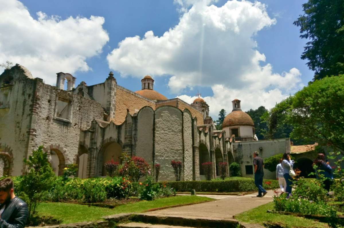 a photo of the stone arches and domes of the convent in Desierto de los Leones, Mexico City, Mexico