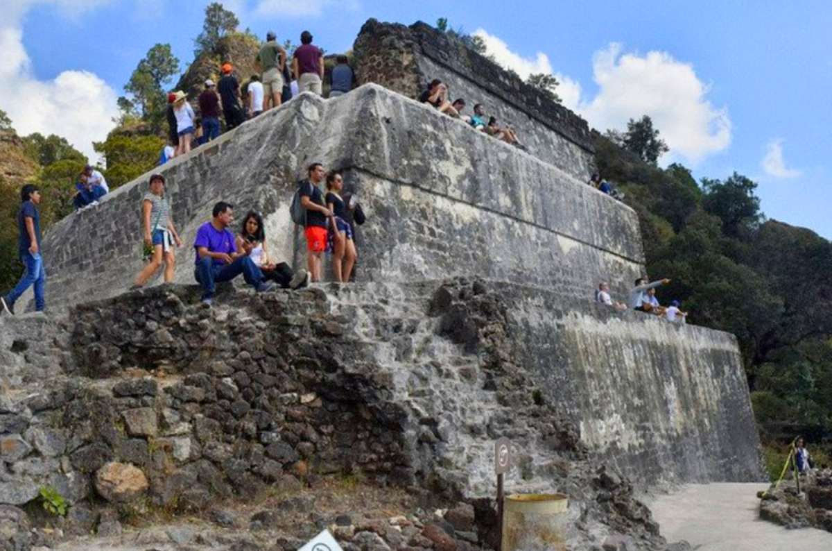 a photo of tourists resting on the stone terraces of the Tepozteco pyramid, Morelos, Mexico