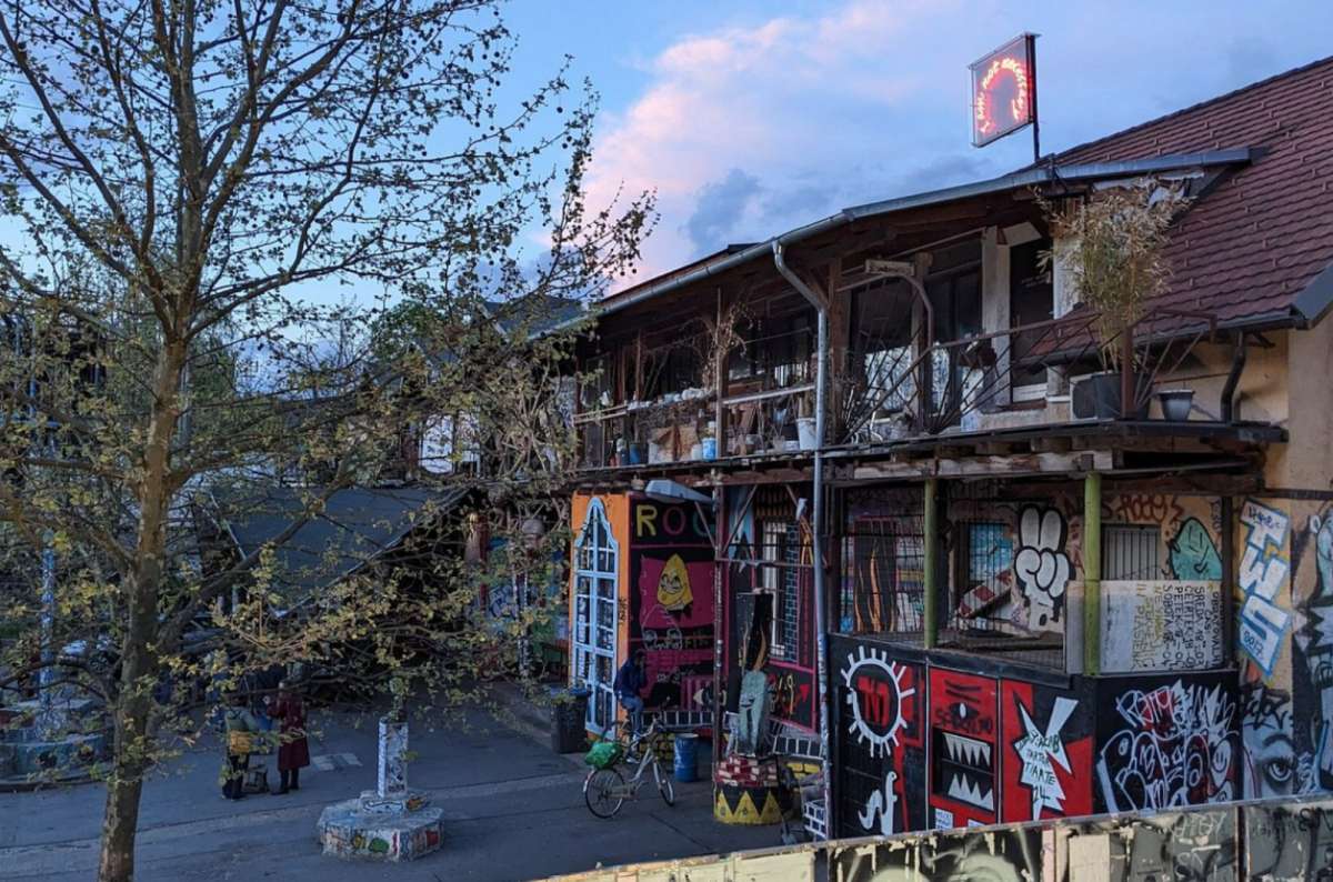 a photo of graffiti-covered buildings in Metelkova Mesto at dusk, Ljubljana, Slovenia