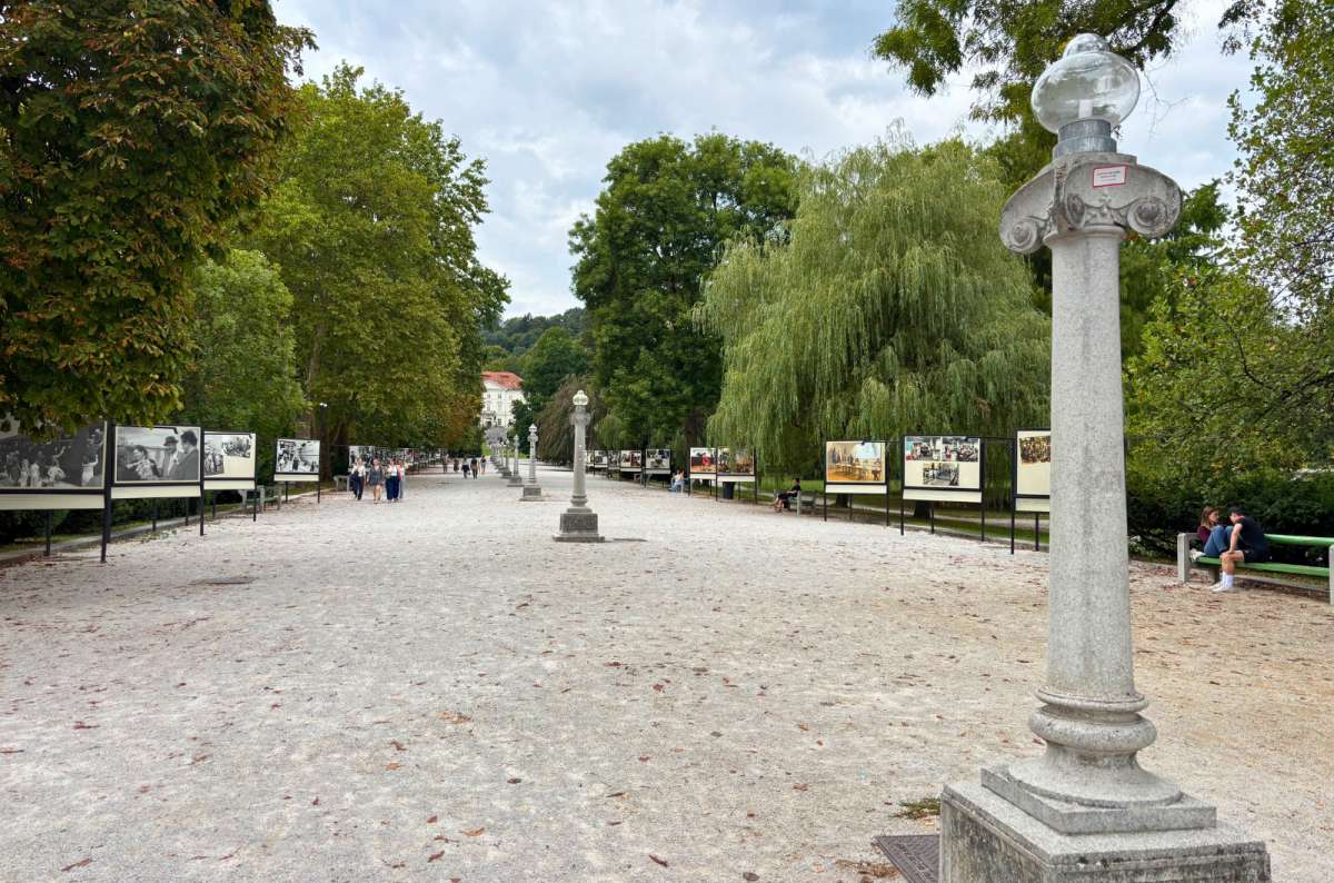a photo of the Jakopič Promenade with an open-air photo exhibition and Tivoli Mansion in the background, Tivoli Park, Ljubljana, Slovenia, photo by Next Level of Travel